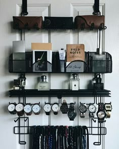 a wall mounted shelf filled with lots of clocks