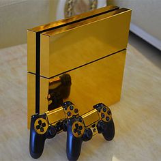 an image of a gold console with two game controllers