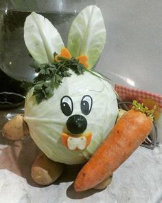 a stuffed animal made to look like a cabbage with carrots on its legs and ears