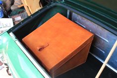 a brown box sitting in the back of a green truck