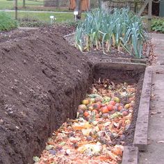 a pile of dirt sitting next to a garden