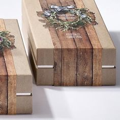 two brown boxes with bows on them sitting next to each other in front of a white background