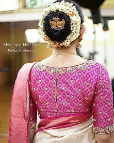 a woman in a pink and white sari with flowers in her hair is looking off to the side