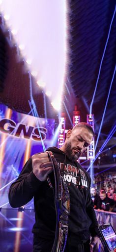 a man standing in front of a crowd holding a cell phone