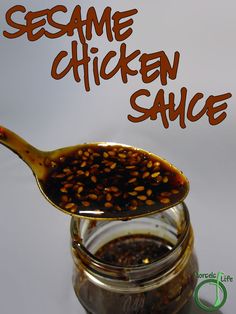 sesame chicken sauce in a glass jar with a spoon full of it and the words sesame chicken sauce on top