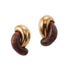 Pair of 18k gold link earrings in 18k gold and wood by Seaman Schepps, retail $5950. DESIGNER: Seaman Schepps MATERIAL: 18k Gold GEMSTONES: Wood DIMENSIONS: Earrings are 28mm x 19mm. MARKED/TESTED: 240777, 750, Shell, Seaman Schepps. WEIGHT: 20.3 grams. CONDITION: Previously Owned, Excellent Condition. Wood And Gold Jewelry, Modern Brown Earrings For Formal Occasions, Seaman Schepps, Vintage Jewlery, Link Earrings, Gold Link, Gold Earrings Designs, April 2024, Gold Wood