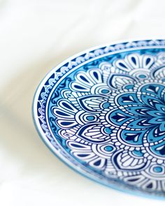 a blue and white plate sitting on top of a table