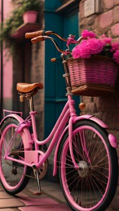 a pink bicycle parked next to a brick building with flowers in the basket on it