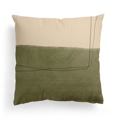 a green and beige pillow sitting on top of a white wall