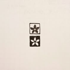 a black and white drawing of a flower in a square with two squares on it