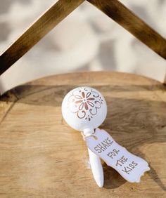 a white bottle stopper sitting on top of a wooden table