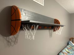 two basketball hoops mounted to the wall above a bed