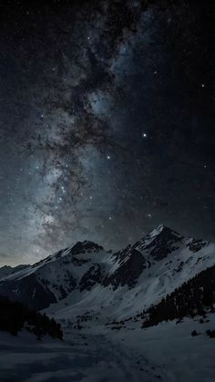 the night sky is filled with stars above snowy mountains and snow - capped peaks,