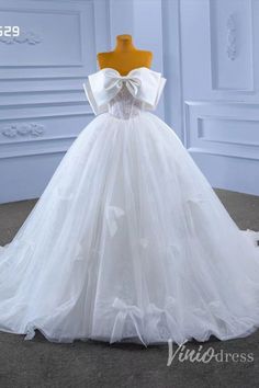 a white wedding dress on display in front of a mannequin