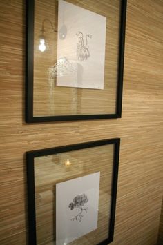 two framed pictures are on the wall next to each other