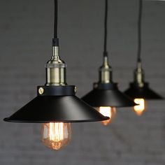 three black and gold lights hanging from the ceiling