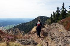 a woman hiking up a mountain trail in the mountains