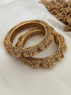 Antique gold finish kada. Amazing detailing.  openable screw kada ( set of 2) Style tip- Pair it with any beautiful traditional outfits  and flaunt with Unique style of collection from us. Perfect match for Festival and Traditional wear.  Take Care Tips-  Kee away from perfume, Hair spray and. Moisture.  Store in dry place , Ziplock bag or Airtight box.    Clean with dry cloth.  Jewellery is the last thing you should wear and first thing you should remove.  -------------------------------------- Jewellery South Indian, Cloth Jewellery, Bangles Gold, Bollywood Style, Ziplock Bags, Bracelet Jewelry, Bollywood Fashion, Gold Bangles, Traditional Outfits