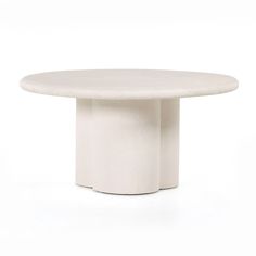 a white round table sitting on top of a white floor