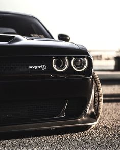 the front end of a black sports car