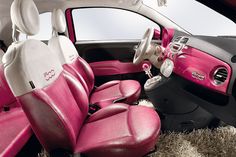 the interior of a pink and white car