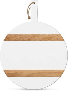 a round wooden cutting board with a white and brown stripe on the bottom, hanging from a rope