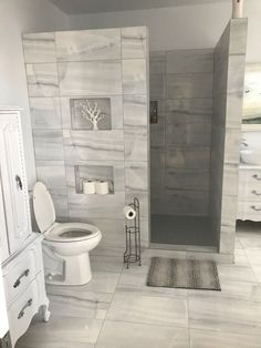 a bathroom with white and gray tile floors, walls and flooring is pictured in this image