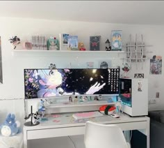 a white desk with a computer on top of it and various pictures above the desk