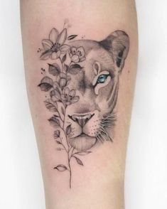 a close up of a person's leg with a tattoo on it and flowers