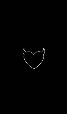 a heart with horns drawn on it in the dark