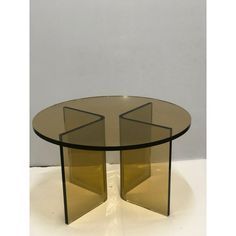 a glass table with two triangular shaped sections on it's sides, against a white background