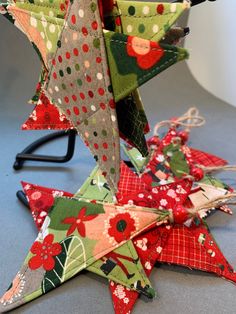 several christmas stars are arranged on the table top, one is red and green with white polka dots