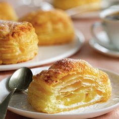 two white plates with pastries on them