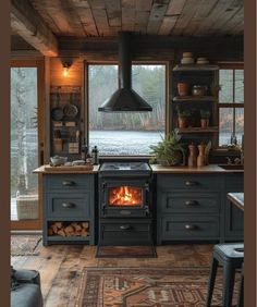 an old fashioned stove in a rustic kitchen with wood flooring and open windows looking out onto the water