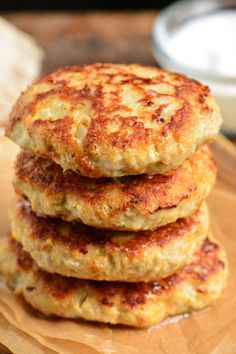 three crab cakes stacked on top of each other with the words chedda ranch chicken burgers