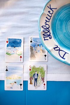 four playing cards with the words happy birthday written on them next to a blue and white plate