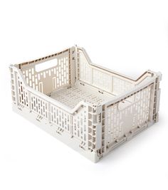 a white plastic crate with lattice design on the sides and bottom, sitting upright against a white background