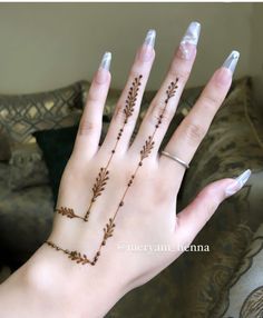 a woman's hand with some tattoos on it