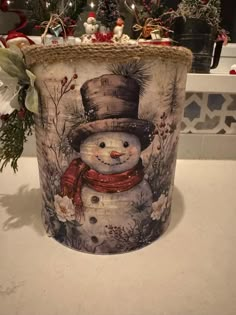 there is a snowman on the side of this trash can