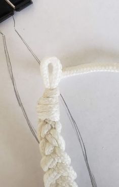 a piece of white rope is attached to a cell phone