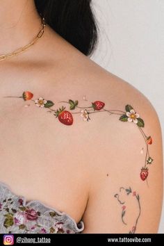 a woman with a strawberry tattoo on her shoulder