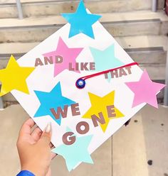 someone is holding up a graduation cap with stars on it