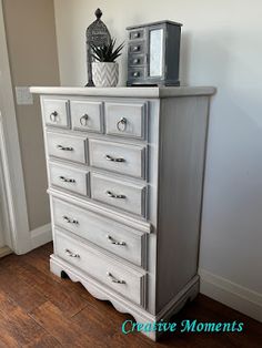 a white dresser sitting on top of a hard wood floor