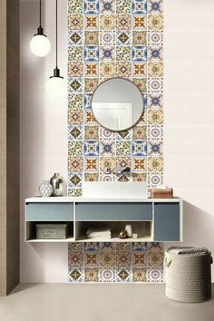 a bathroom with a sink, mirror and tiled wall behind the vanity area is decorated in multicolored tiles