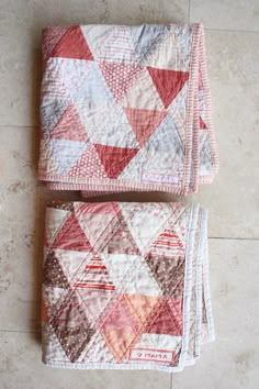 two quilts are laying on the floor next to each other, one is red and white