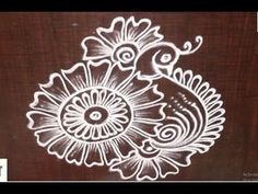 an intricately designed design on the side of a wooden door with white paint and flowers