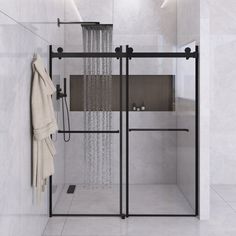 a bathroom with a glass shower door and white tile walls, along with a towel rack on the wall