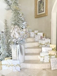 a staircase decorated with white and gold christmas presents