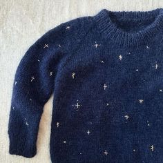 a blue sweater with white stars on it