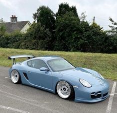 a blue sports car parked in a parking lot